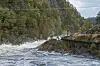 Elva Otra raser forbi langs den gamle nedlagte Setesdalsbanen og tømmerrenne ved Steinsfoss i Vennesla